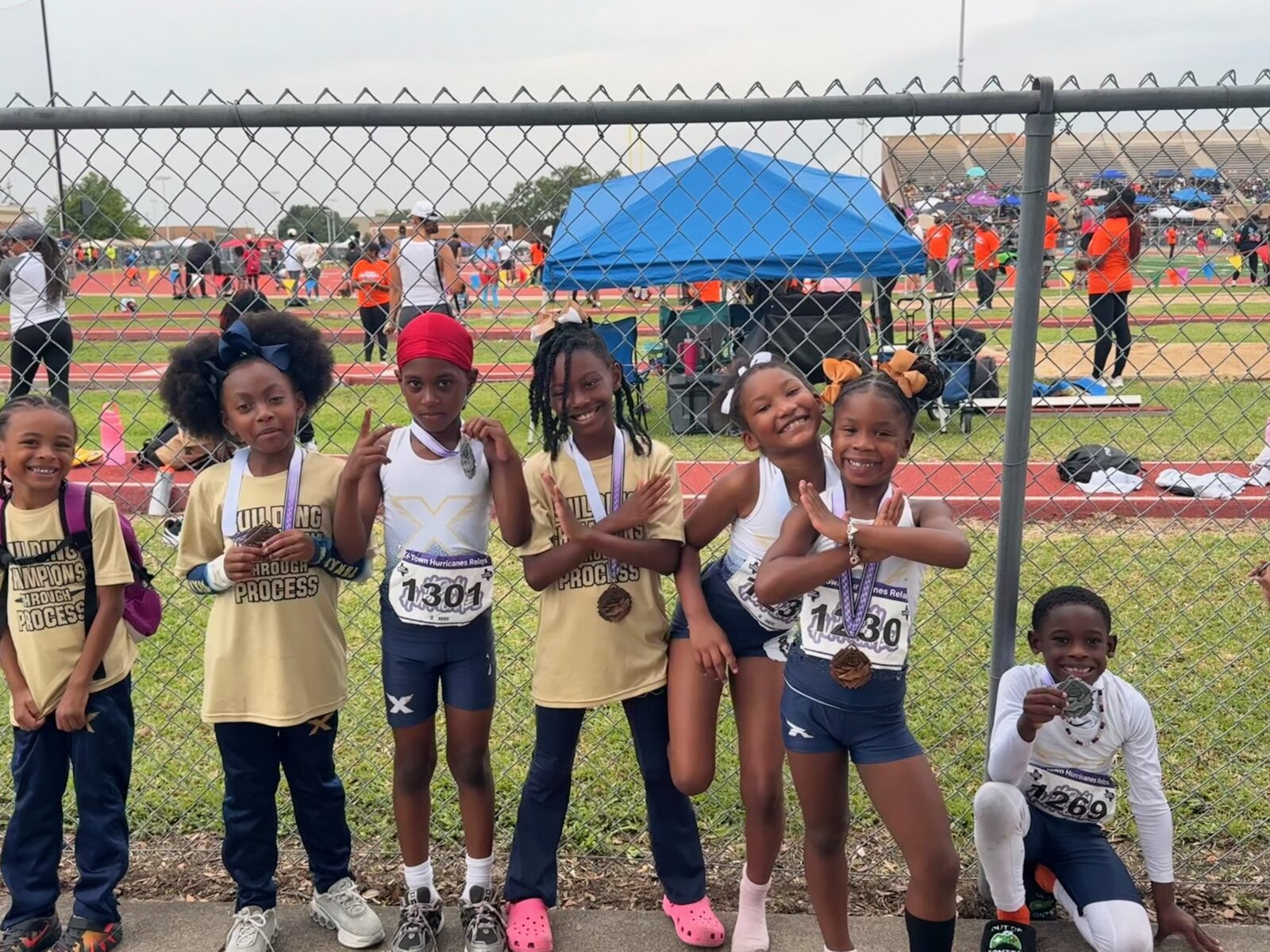 Texas Speed Elite squad posing trackside with medals